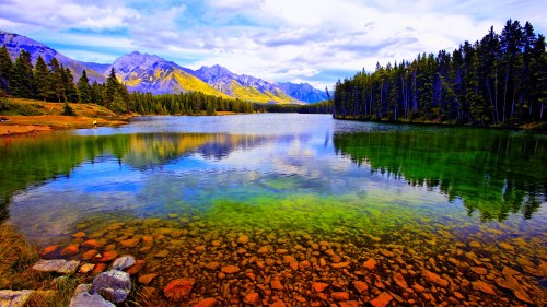 Reflection of mountains and trees in a lake, Lake Johnson, Banff National Park, Alberta, Canada